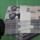 A man walks past a promotional banner showing a pile of Nigerian naira in Lagos in 2010.